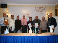 DevPar consultant stands behind the head table with 7 participants of the training program