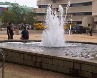 2 men by a fountain in front of a museum