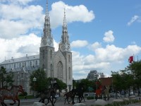 Notre-Dame Cathedral Basilica in Ottawa with a waving Canadian flag