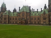 stone Parliament Buildings with green copper roof