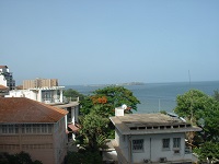 looking over buildings to an island in the sea