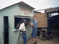 2 men buying phone credits at a kiosk