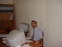 An Armenian man works at  a computer